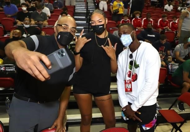 Liz Cambage of the Las Vegas Aces poses for a photo with Dennis Scott of NBA TV and Dwayne Wade during the 2021 Las Vegas Summer League on August 9,...
