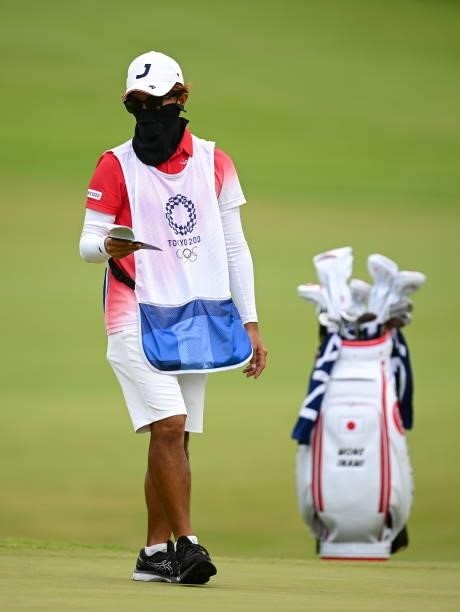 Saitama , Japan - 7 August 2021; Tomoaki Okushima, caddie to Mone Inami of Japan, on the 18th during round four of the women's individual stroke play...