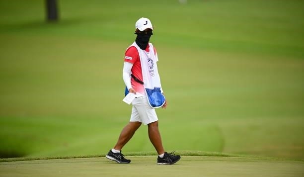 Saitama , Japan - 7 August 2021; Tomoaki Okushima, caddie to Mone Inami of Japan, on the 18th during round four of the women's individual stroke play...