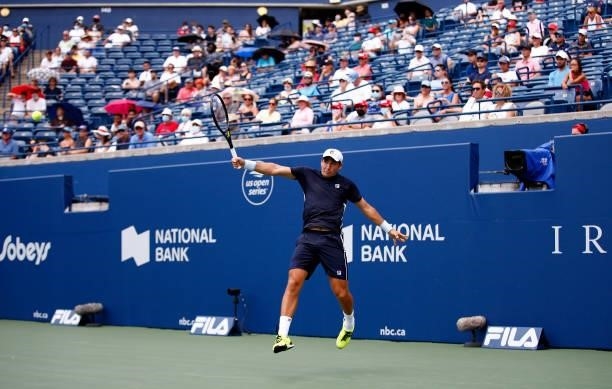 Dusan Lajovic of Serbia hits a shot against Felix Auger-Aliassime of Canada during the second round on Day Three of the National Bank Open at Aviva...