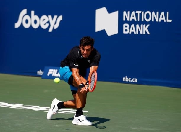 Cristian Garin of Chile hits a shot against John Isner of the United States during the second round on Day Three of the National Bank Open at Aviva...