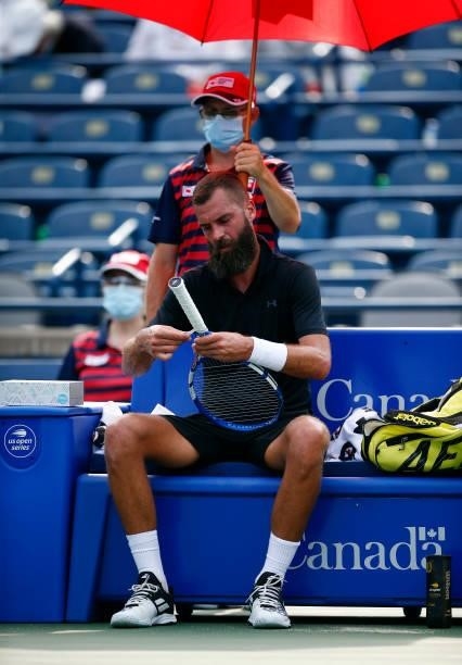 Benoit Paire of France tapes the grip on his racket during his second round match against Diego Schwartzman of Argentina on Day Three of the National...