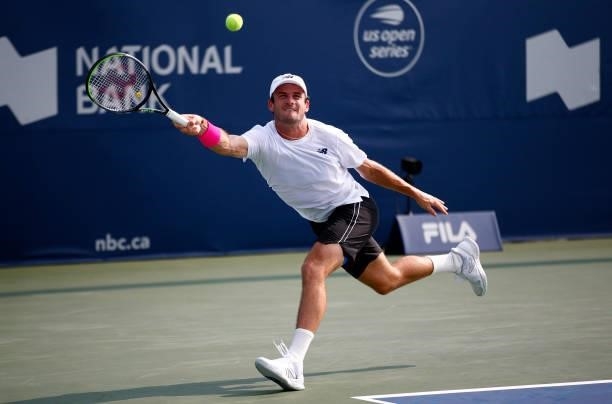 Tommy Paul of the United States hits a shot against Roberto Bautista Agut of Spain during the second round on Day Three of the National Bank Open at...