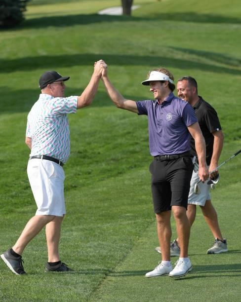 James Nicholas celebrates his chip in from the first fairway with his Pro-Am partner prior to the Korn Ferry Tours Pinnacle Bank Championship...