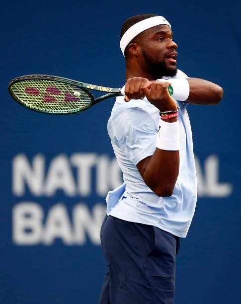 Frances Tiafoe of the United States hits a shot against Denis Shapovalov of Canada during the second round on Day Three of the National Bank Open at...