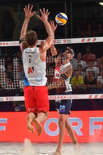 Clemens Doppler of Austria spikes and Marco Krattiger of Switzerland blocks during the pool match between Marco Krattiger and Yves Haussener of...
