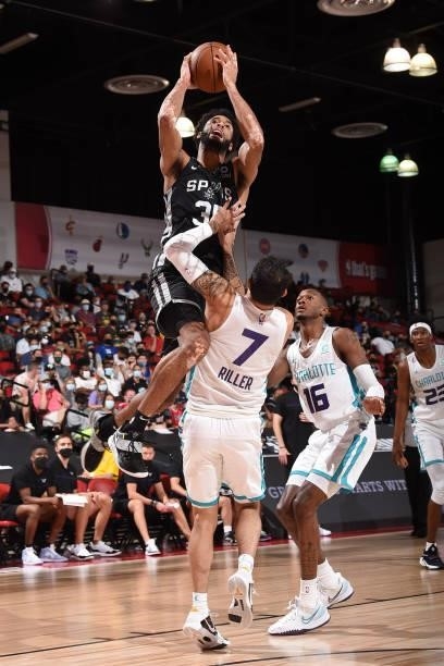 Nate Renfro of the San Antonio Spurs drives to the basket against the Charlotte Hornets during the 2021 Las Vegas Summer League on August 12, 2021 at...