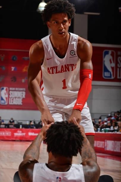 Jalen Johnson of the Atlanta Hawks helps up teammate during the game against the Philadelphia 76ers during the 2021 Las Vegas Summer League on August...