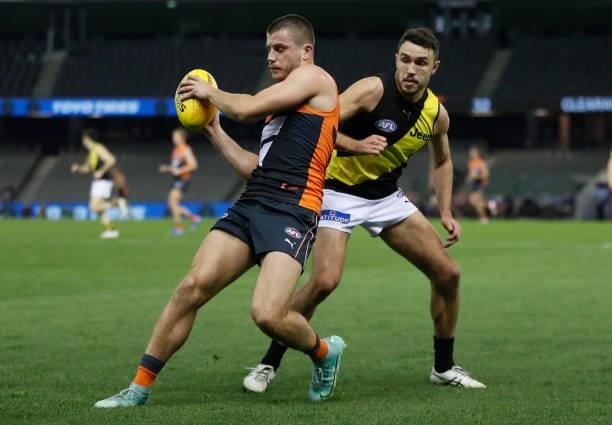Xavier O'Halloran of the Giants and Shane Edwards of the Tigers in action during the 2021 AFL Round 22 match between the GWS Giants and the Richmond...