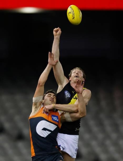 Dylan Grimes of the Tigers and Tim Taranto of the Giants compete for the ball during the 2021 AFL Round 22 match between the GWS Giants and the...