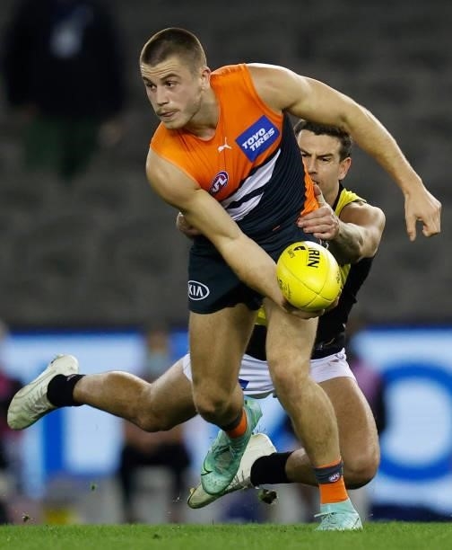 Xavier O'Halloran of the Giants is tackled by Jack Graham of the Tigers during the 2021 AFL Round 22 match between the GWS Giants and the Richmond...