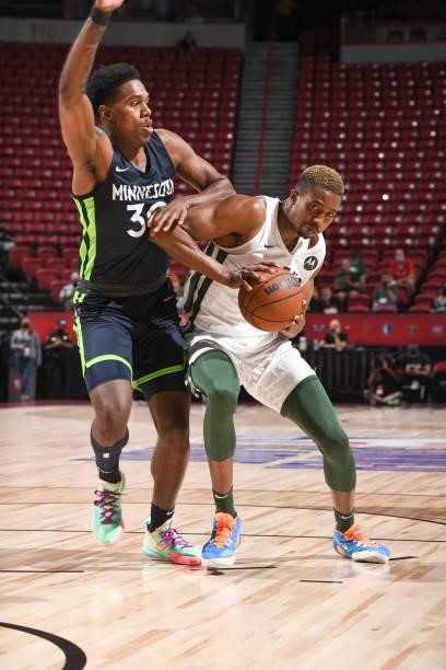 Mamadi Diakite of the Milwaukee Bucks handles the ball as Nathan Knight of the Minnesota Timberwolves plays defense during the 2021 Las Vegas Summer...