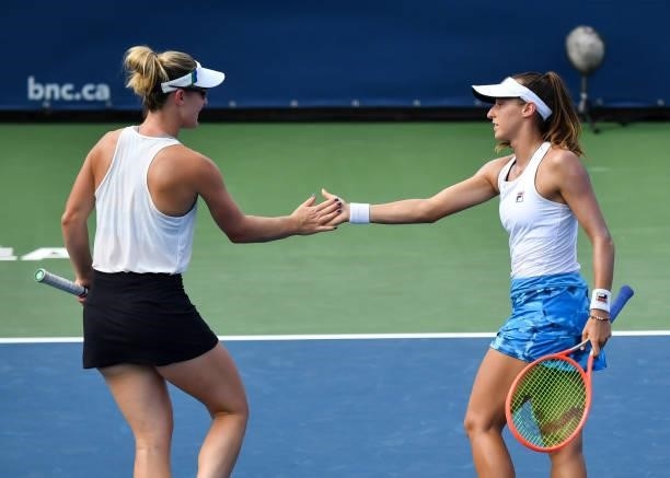 Luisa Stefani of Brazil and Gabriela Dabrowski of Canada encourage each other during their Womens Doubles Quarterfinals match against Elise Mertens...