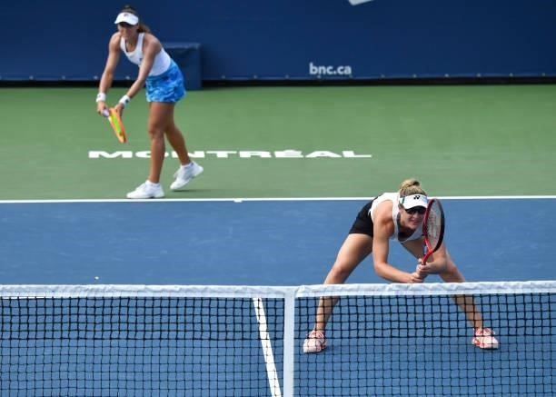 Luisa Stefani of Brazil serves while teammate Gabriela Dabrowski of Canada covers the net during their Womens Doubles Quarterfinals match against...