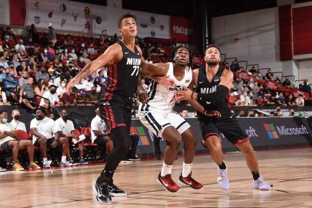 Omer Yurtseven and Max Strus of the Miami Heat fight Jarrell Brantley of the Utah Jazz for position during the 2021 Las Vegas Summer League on August...