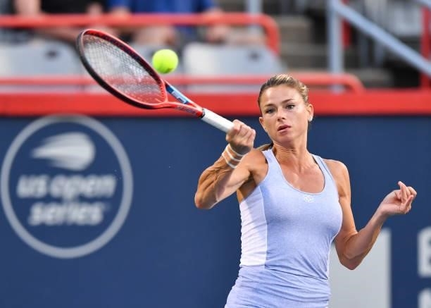 Camila Giorgi of Italy hits a return during her Womens Singles Quarterfinals match against Cori Gauff of the United States on Day Five of the...
