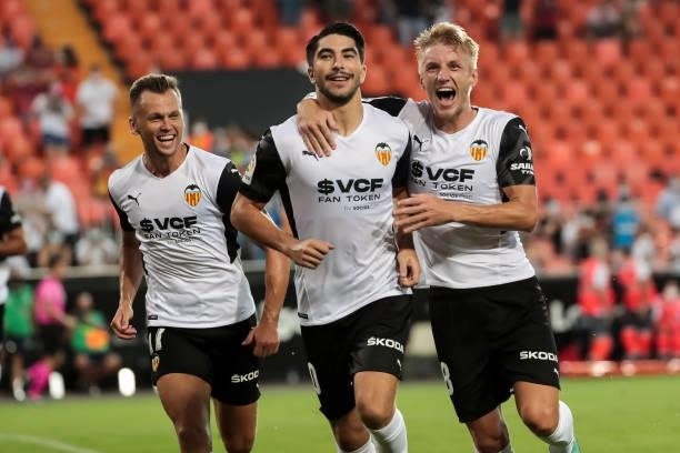 Carlos Soler of Valencia CF celebrate after scoring the 1-0 goal with his teammate Denis Cheryshev of Valencia CF and Daniel Wass of Valencia CF...