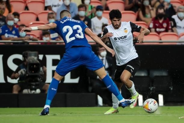 Stefan Mitrovic of Getafe CF and Gonzalo Guedes of Valencia CF during La liga match between Valencia CF and Getafe CF at Mestalla Stadium on August...