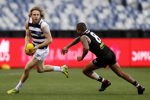 Cameron Guthrie of the Cats in action ahead of Bradley Hill of the Saints during the 2021 AFL Round 22 match between the Geelong Cats and the St...
