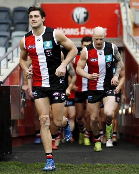 Jack Steele of the Saints leads his team on to the ground during the 2021 AFL Round 22 match between the Geelong Cats and the St Kilda Saints at...