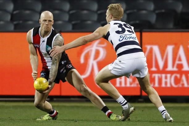 Zak Jones of the Saints controls the ball against Zach Guthrie of the Cats during the 2021 AFL Round 22 match between the Geelong Cats and the St...