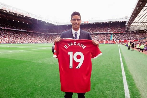 Raphael Varane of Manchester Unite poses with a shirt as he is unveiled prior to the Premier League match between Manchester United and Leeds United...