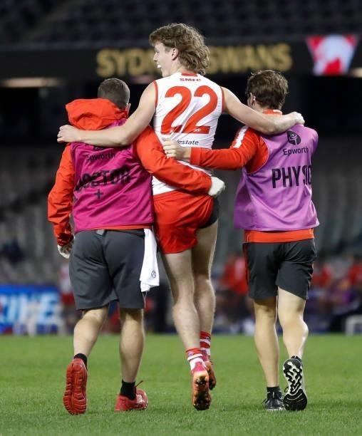 Nick Blakey of the Swans leaves the field injured during the 2021 AFL Round 22 match between the North Melbourne Kangaroos and the Sydney Swans at...