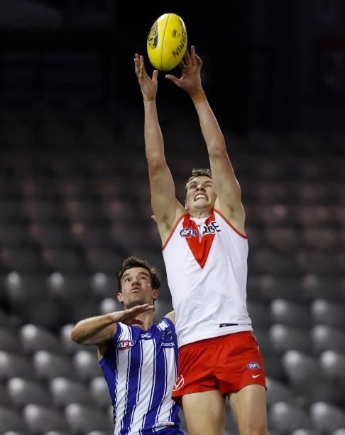 Jordan Dawson of the Swans and Jy Simpkin of the Kangaroos compete for the ball during the 2021 AFL Round 22 match between the North Melbourne...