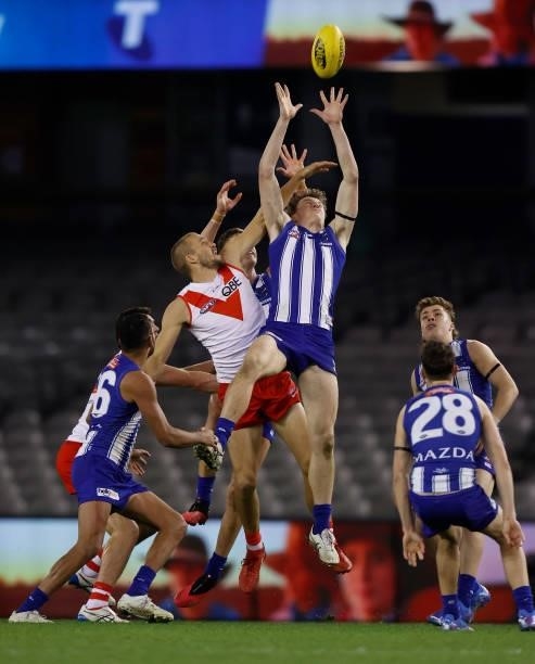 Nick Larkey of the Kangaroos and Sam Reid of the Swans compete for the ball during the 2021 AFL Round 22 match between the North Melbourne Kangaroos...
