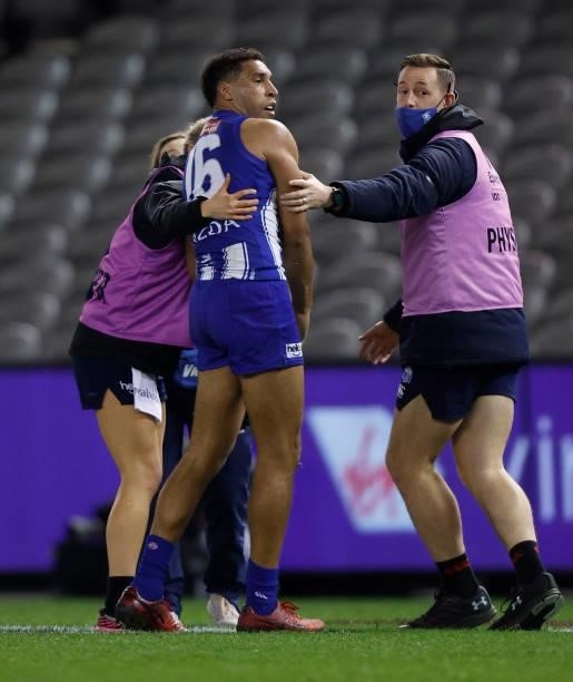 Aiden Bonar of the Kangaroos receives medical attention during the 2021 AFL Round 22 match between the North Melbourne Kangaroos and the Sydney Swans...