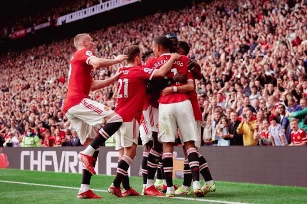 Mason Greenwood of Manchester United celebrates with Bruno Fernandes and Paul Pogba during the Premier League match between Manchester United and...
