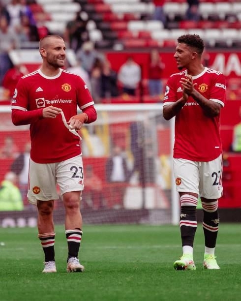 Jadon Sancho of Manchester United applauds the fans with Luke Shaw at the end of the Premier League match between Manchester United and Leeds United...