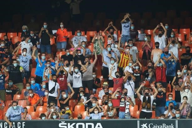 Valencia fans celebrates during the La Liga Santader match between Valencia CF and Getafe CF at Estadio Mestalla on August 13, 2021 in Valencia,...