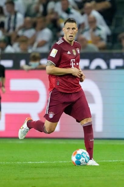 Niklas Suele of Bayern Muenchen controls the ball during the Bundesliga match between Borussia Moenchengladbach and FC Bayern Muenchen at...
