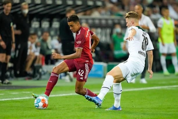 Jamal Musiala of Bayern Muenchen and Nico Elvedi of Borussia Moenchengladbach battle for the ball during the Bundesliga match between Borussia...