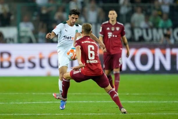 Lars Stindl of Borussia Moenchengladbach and Joshua Kimmich of Bayern Muenchen battle for the ball during the Bundesliga match between Borussia...