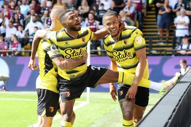 Emmanuel Dennis of Watford celebrates scoring the opening goal for Watford with William Troost-Ekong during the Premier League match between Watford...
