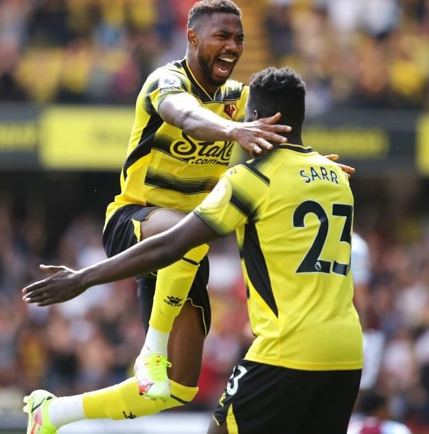 Emmanuel Dennis of Watford celebrates scoring their 1st goal with Ismaila Sarr during the Premier League match between Watford and Aston Villa at...