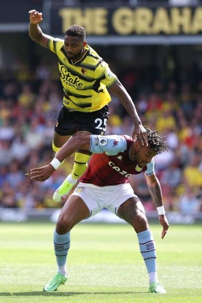 Emmanuel Dennis of Watford and Tyrone Mings of Villa during the Premier League match between Watford and Aston Villa at Vicarage Road on August 14,...