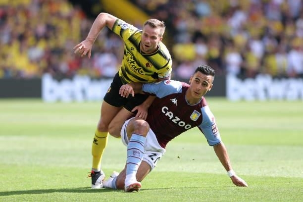 Tom Cleverley of Watford and Anwar El Ghazi of Villa during the Premier League match between Watford and Aston Villa at Vicarage Road on August 14,...