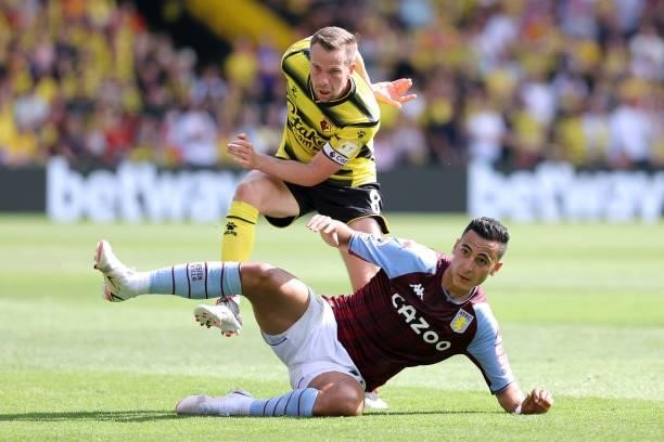 Tom Cleverley of Watford and Anwar El Ghazi of Villa during the Premier League match between Watford and Aston Villa at Vicarage Road on August 14,...