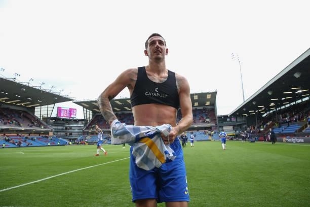 Lewis Dunk of Brighton and Hove Albion gives his shirt to fans during the Premier League match between Burnley and Brighton & Hove Albion at Turf...