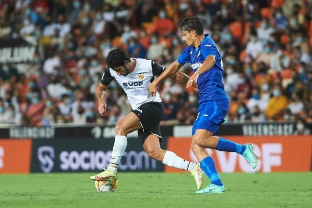 Gonzalo Guedes of FC Valencia and Enes Unal of FC Getafe battle for the ball during the La Liga Santader match between Valencia CF and Getafe CF at...