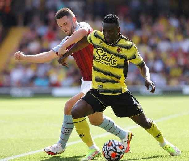 John McGinn of Villa and Peter Etebo of Watford during the Premier League match between Watford and Aston Villa at Vicarage Road on August 14, 2021...