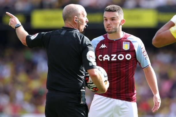 John McGinn of Villa argues with referee Mike Dean during the Premier League match between Watford and Aston Villa at Vicarage Road on August 14,...