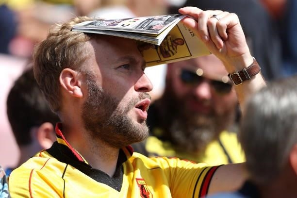 Watford fan uses his programme to shield his eyes from the harsh sunlight during the Premier League match between Watford and Aston Villa at Vicarage...