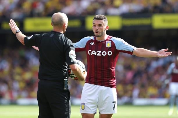 John McGinn of Villa argues with referee Mike Dean during the Premier League match between Watford and Aston Villa at Vicarage Road on August 14,...