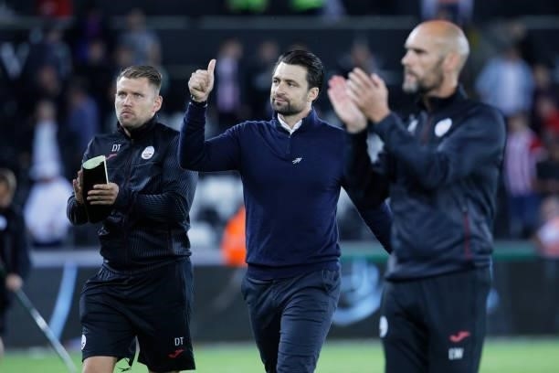 Swansea City manager Russel Martin with assistant head coach Luke Williams greet the home crowd after the Sky Bet Championship match between Swansea...