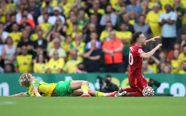Diogo Jota of Liverpool is fouled by Todd Cantwell of Norwich City during the Premier League match between Norwich City and Liverpool at Carrow Road...