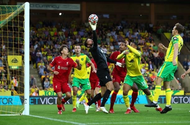 Alisson of Liverpool stretches to make a save during the Premier League match between Norwich City and Liverpool at Carrow Road on August 14, 2021 in...